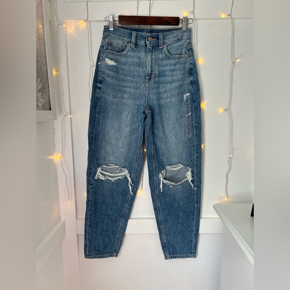 Lighter blue mom jean with two holes on the knees